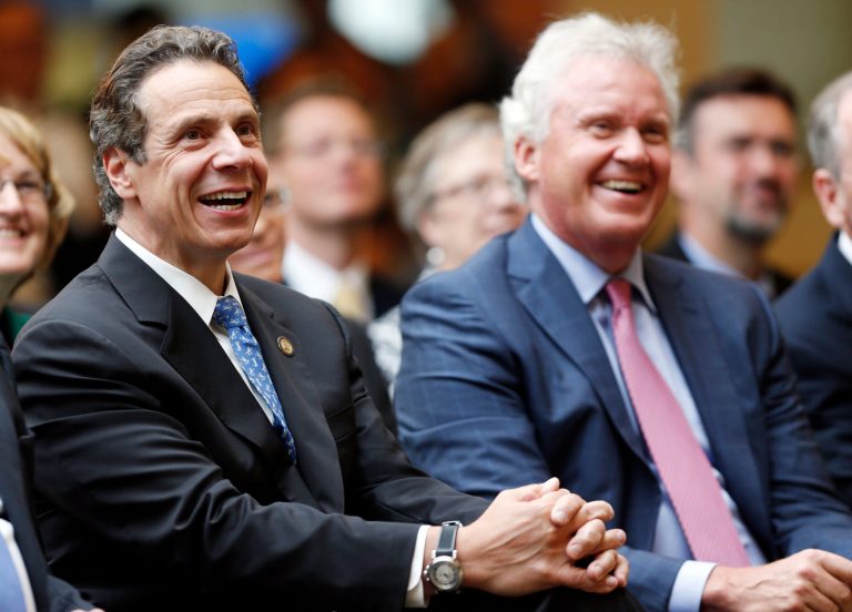 New York Gov. Andrew Cuomo, left, General Electric CEO Jeffrey Immelt listen to a speaker during an economic development news conference at GE Global Research on Tuesday, July 15, 2014, in Niskayuna, N.Y.  Cuomo joined Immelt Tuesday at the GE research office to announce that New York state is teaming with General Electric and other companies on a $500 million initiative designed to spur research and development in miniature electronic components.  (AP Photo/Mike Groll)