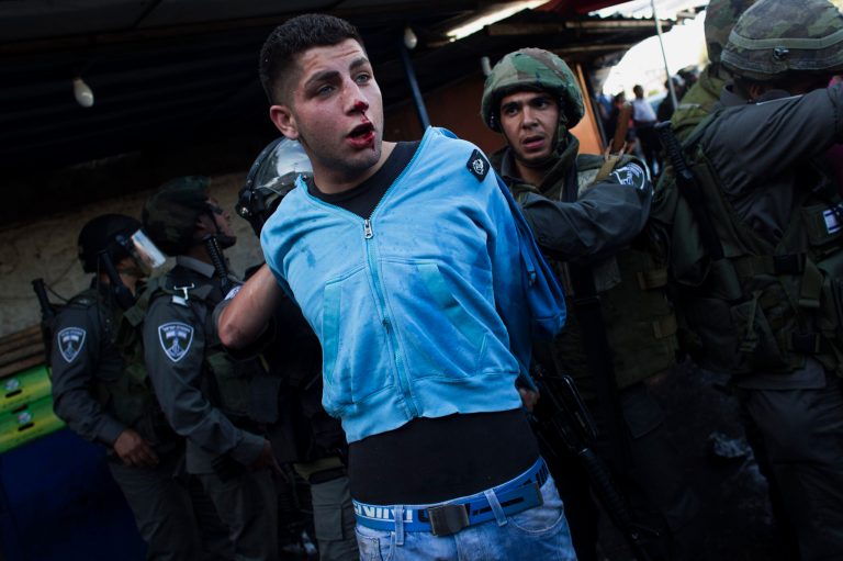 Israeli security forces detain a Palestinian man during clashes that erupted during a rally marking Nakba Day in Jerusalem, Wednesday, May 15, 2013. Palestinians annually mark the 