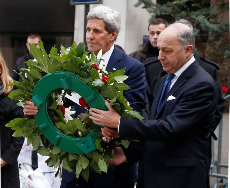 U.S. Secretary of State John Kerry, left, and French Foreign Minister Laurent Fabius lay a wreath at the site of the Charlie Hebdo terrorist attack in Paris, Friday, Jan. 16, 2015. Kerry paid his respects Friday to the victims of last week's terrorist attacks in Paris in a show of American solidarity with the French people. (AP Photo/Michel Euler)