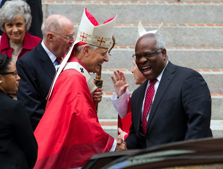 Cardinal Donald Wuerl, archbishop of Washington, shake hands with U.S. Supreme Court Justice Clarence Thomas, as they leave the church after the Red Mass at St. Mathews Cathedral in Washington on Sunday, Oct. 4, 2015. The Supreme Court's new term starts Monday, Oct. 5. ( AP Photo/Jose Luis Magana)