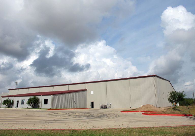 A corrugated steel warehouse is shown Tuesday, June 24, 2014, in McAllen, Texas, that the U.S. government plans to turn into a processing facility for unaccompanied children who have entered the country illegally, according to construction permits. The permits show plans for four fence-enclosed pods inside the warehouse that could eventually accommodate about 1,000 children. The Border Patrol has been overwhelmed by more than 52,000 unaccompanied minors that have been arrested since October 2013, after entering the Unites States illegally. (AP Photo/Christopher Sherman)