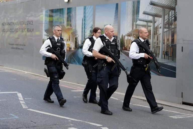 A group of armed British police officers walk together after an attack in the London Bridge area of London on Sunday. (AP Photo/Matt Dunham)