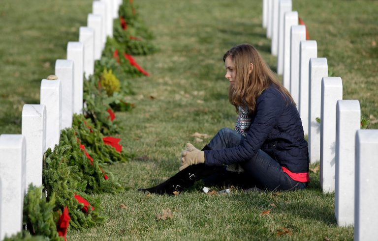 At Arlington National Cemetery, 30,000 graves may have to forego the commemorative garland due to a lack of funding. (AP Photo/Luis M. Alvarez)