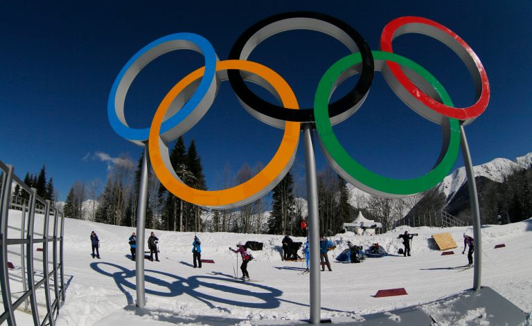 Cross country skiers pass by the Olympic rings prior to the 2014 Winter Olympics, Wednesday, Feb. 5, 2014, in Krasnaya Polyana, Russia. (AP Photo/Dmitry Lovetsky)