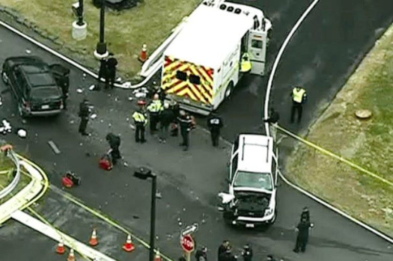 In this image made from video and released by WJLA-TV, authorities investigate the scene of a accident near a gate to Fort Meade, Md., on Monday, March 30, 2015. A spokesman at Fort Meade says two people are being treated for injuries at one of the gates of the sprawling Army installation near Baltimore. (AP Photo/WJLA-TV)Â 