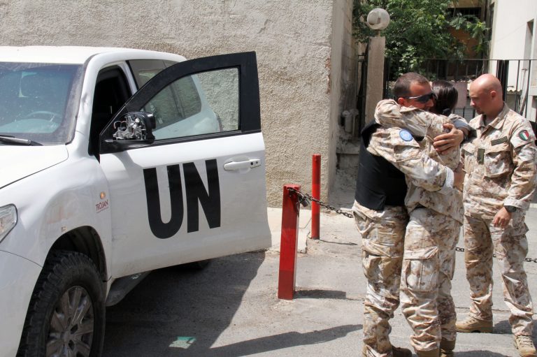   UN observers welcome their comrades upon their return from al-Haffa, in northern Syria, to Damascus, Syria on Saturday, June 16, 2012. U.N. Observers in Syria suspended their activities and patrols Saturday because of escalating violence in the country, the head of the mission said, the strongest sign yet that an international peace plan for Syria is disintegrating. (AP Photo/Bassem Tellawi)  