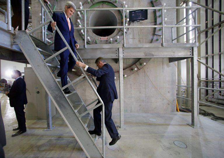 Secretary of State John Kerry, left, and British Foreign Secretary Philip Hammond climb down the steps of a platform after viewing the blade of a wind turbine at the Wind Technology Testing Center, Thursday, Oct. 9, 2014 in Boston. Hammond walked down the steps backwards. (AP Photo/Stephan Savoia)