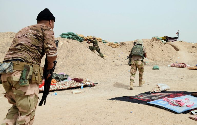In this Saturday, Sept. 12, 2015 photo, Iraqi security forces backed by Sunni and Shiite volunteers clash with Islamic State group militants at the front line in the suburbs of Ramadi, Anbar province, Iraq. (AP Photo)