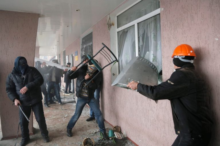 Pro-Russian men storm a police station in the eastern Ukrainian town of Horlivka on Monday, April 14, 2014.  Several government buildings have fallen to mobs of Moscow loyalists in recent days as unrest spreads across the east of the country.  (AP Photo/Efrem Lukatsky)