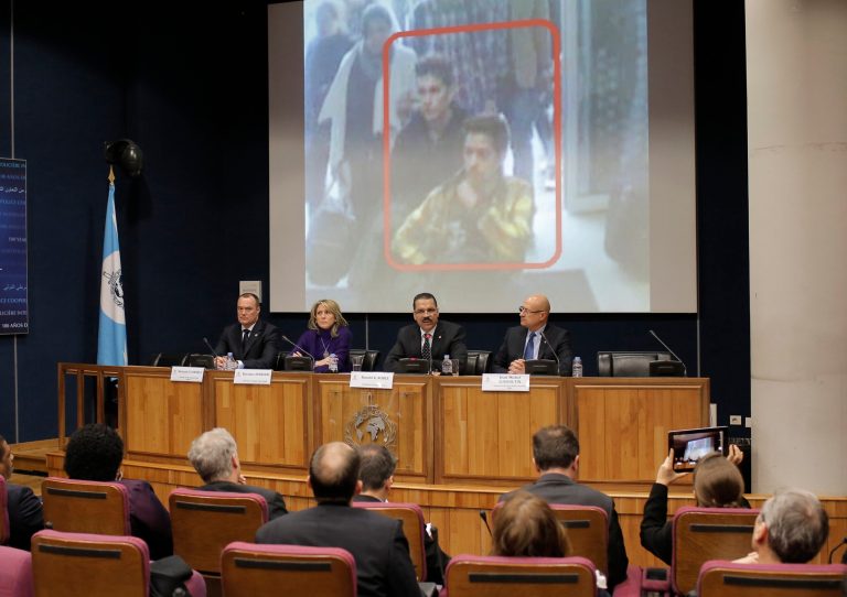 The image of two Iranian who were traveling with stolen passports on a missing Malaysia Arlines jetliner is displayed on a screen during a presser at the Interpol headquarters in Lyon, central France, Tuesday, March 11, 2014. (AP Photo/Laurent Cipriani)