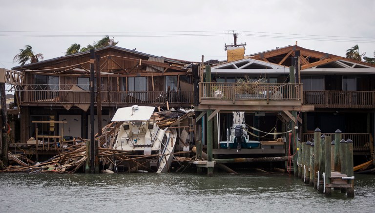 A boat sits on a dock after Hurricane Harvey passed through Port Aransas, Texas, Sunday, Aug. 27, 2017. Harvey made landfall in Texas on Friday night as the strongest hurricane to hit the U.S. in more than a decade. By Saturday afternoon it had been downgraded into a tropical storm, but it had dumped over a dozen inches of rain on some areas and forecasters were warning that it could cause catastrophic flooding in the coming days. (Nick Wagner/Austin American-Statesman via AP)