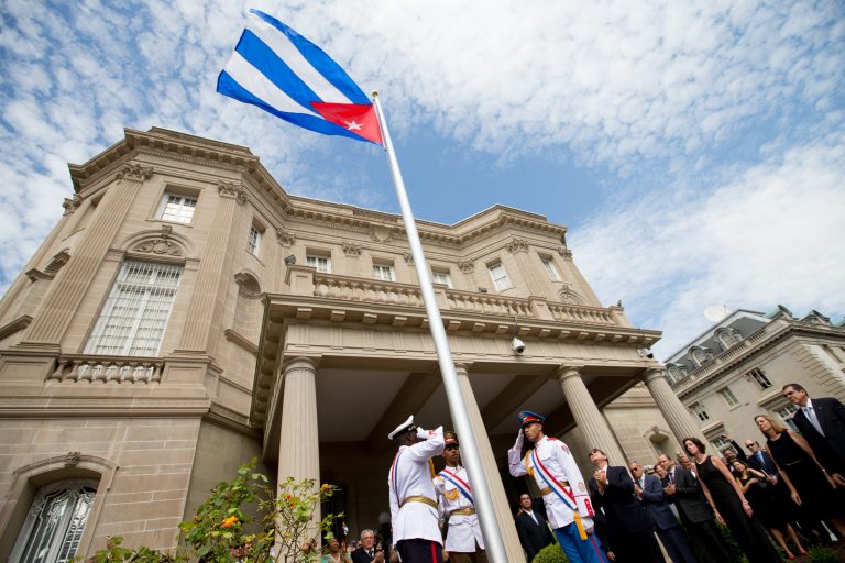 Cuban Foreign Minister Bruno Rodriguez, right of center, applauds with other dignitaries after raising the Cuban flag over their new embassy in Washington, Monday. (AP Photo/Andrew Harnik, Pool)