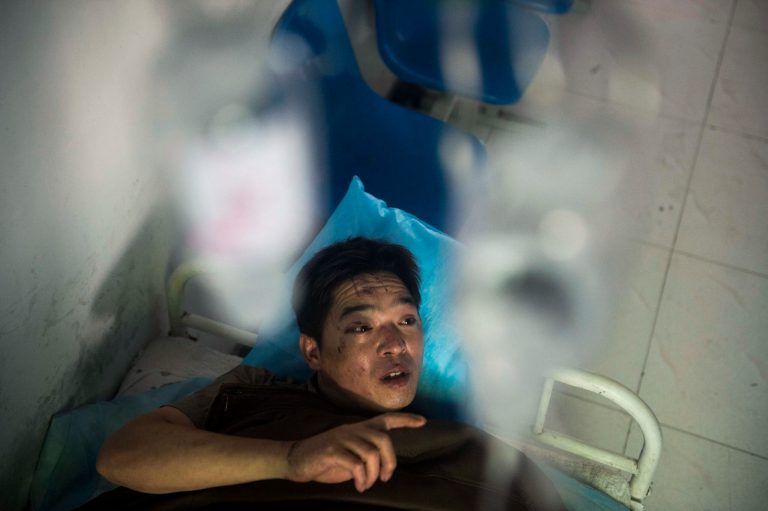 In this photo released by China's Xinhua News Agency, miner Duan Xukang receives a treatment at a hospital in Fukang City, northwest China's Xinjiang Uygur Autonomous Region, after being rescued following a gas explosion at a coal mine in western China, Sunday, July 6, 2014. Rescuers on Sunday worked to free 17 miners trapped following the blast at the mine that happened on Saturday evening, according to the news agency.  (AP Photo/Xinhua, Jiang Wenyao) NO SALES
