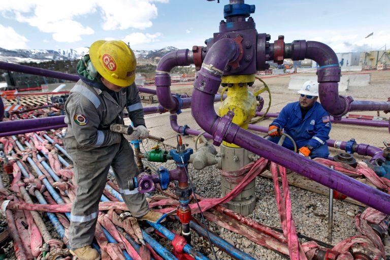 FILE - In this March 29, 2013 file photo, workers tend to a well head during a hydraulic fracturing operation at an Encana Oil & Gas (USA) Inc. gas well outside Rifle, in western Colorado. Wyoming, New Mexico and other states will lose more than $400 million in mineral payments over the next decade under a budget deal nearing final approval in the Senate. A provision in the budget deal preserves a 2 percent fee charged by the government on royalties from energy companies that purchase oil and gas leases on federal land. The fee effectively set a 51-49 split, favoring the federal government, on energy royalties. The government last year paid $2.1 billion to 35 states under the program, with the largest payments going to five Western states: Wyoming, New Mexico, Utah, Colorado and California.  (AP Photo/Brennan Linsley, File)