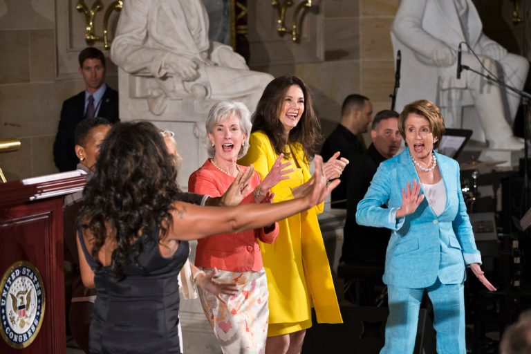From right, House Minority Leader Nancy Pelosi, D-Calif., actor and political activist Lynda Carter, and Health and Human Services Secretary Kathleen Sebelius, join singer Mary Wilson, far left, and dance to The Supremes song 