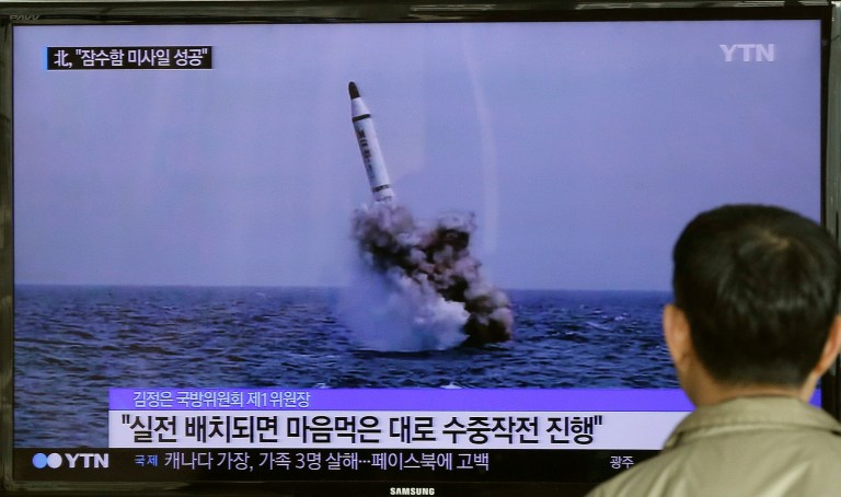 A South Korean man watches a TV news program showing an image published in North Korea's Rodong Sinmun newspaper of North Korea's ballistic missile believed to have been launched from underwater, at Seoul Railway station in Seoul, South Korea, Saturday, May 9, 2015. (AP Photo/Ahn Young-oon)