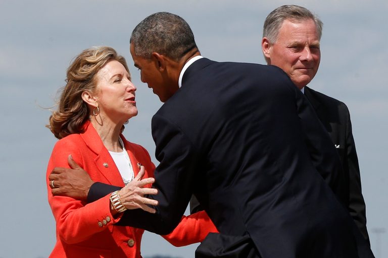 In this Aug. 26, 2014 file photo, President Barack Obama is greeted by Sen. Kay Hagan, D-N.C., left, as he arrives at North Carolina Air National Guard Base in Charlotte, N.C. In a radio ad produced by Hagan's campaign, currently on the air in North Carolina, Obama offers his endorsement of Hagan and says their priorities align. (AP Photo/Charles Dharapak)