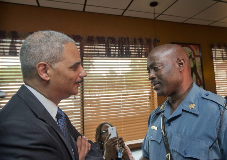 Attorney General Eric Holder, left, talks with Capt. Ron Johnson of the Missouri State Highway Patrol at Drake's Place Restaurant,August 20, 2014 in Ferguson, Mo. (Photo by Pablo Martinez Monsivais-Pool/Getty Images)