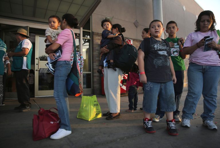 Central American immigrants released from Border Patrol detention wait at a Greyhound bus station in McAllen, Texas on July 25. They will continue on to various cities across the U.S. (Getty images/John Moore)