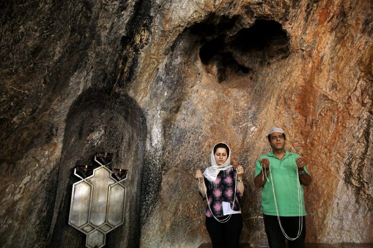 In this Friday, June 13, 2014 photo, Zoroastrians pray in Chak Chak, a mountain shrine, some 600 kilometers (370 miles) southeast of the capital Tehran, Iran. Adherents of the Zoroastrian religion from around the world gathered at a mountain shrine in central Iran this week to celebrate their Persian roots, praying in remembrance of a princess who fled the 7th century Arab invasion. At Chak Chak, believers gathered to remember Nikbanou, a heroine of the faith who according to tradition took shelter in the mountain and prayed for help. Miraculously, the mountain was said to have opened up and given protection to the princess, the youngest daughter of the last king of the Persian Sassanian empire. (AP Photo/Ebrahim Noroozi)