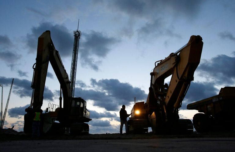 In early morning darkness, a worker prepares heavy machinery for the day as rebuilding work continues on the beach area between Seaside Heights and Seaside Park, N.J., on Tuesday, Oct. 29. Millions of tax dollars that could go toward Hurricane Sandy recovery are instead going to research on the storm recovery process, according to a nonprofit government watchdog group. (AP Photo/Mel Evans)