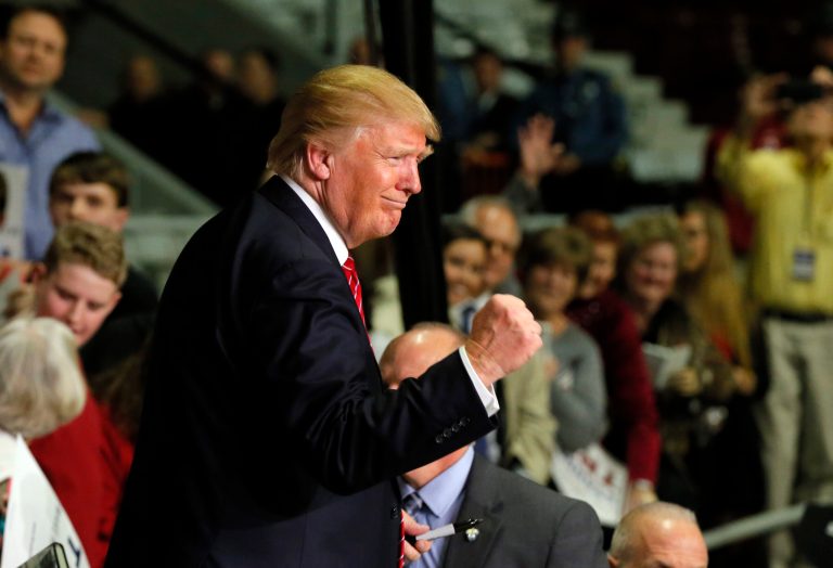 Republican presidential candidate Donald Trump pumps his fist as supporters cheer him after a speech at a campaign stop, Wednesday, Feb. 3, 2016, in Little Rock, Ark. (AP Photo/Tony Gutierrez)