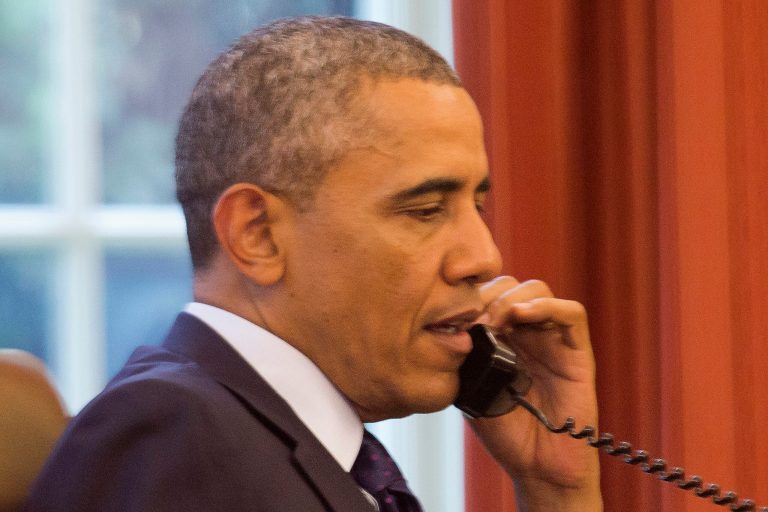 President Obama speaks on the phone during a conference call to discuss new steps to reduce carbon pollution from power plants. (AP/Jacquelyn Martin)