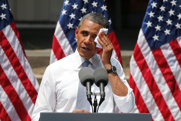 FILE - This June 25, 2013 file photo shows President Barack Obama wiping perspiration from his face as he speaks about climate change at Georgetown University in Washington. The Obama administration is poised to unveil first-ever rules limiting greenhouse gas emissions from the power plants that dot the U.S. map. President Barack Obama says the rules are essential to curb climate change, but critics disagree.  (AP Photo/Charles Dharapak, File)
