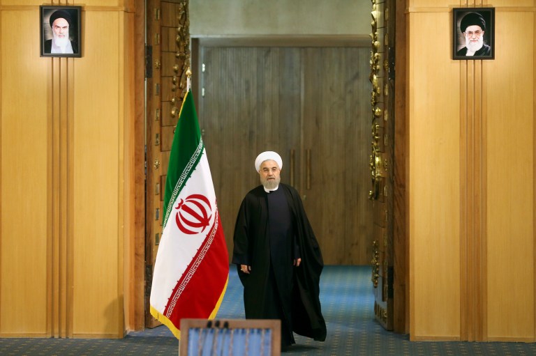 Under portraits of the late Iranian revolutionary founder Ayatollah Khomeini, top left, and Supreme Leader Ayatollah Ali Khamenei, President Hassan Rouhani arrives for a news conference in Tehran, Iran. Since Obama struck the nuclear deal, Iran has gone out of its way to confirm fears that it's untrustworthy. (AP Photo/Ebrahim Noroozi)