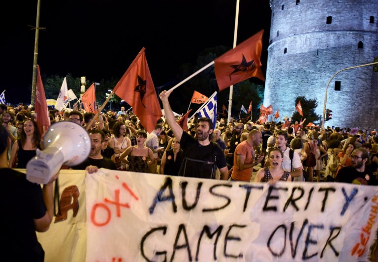 Supporters of the No vote celebrate after the results of the referendum in the northern Greek port city of Thessaloniki, Sunday, July 5, 2015. Greeks overwhelmingly rejected creditors' demands for more austerity in return for rescue loans in a critical referendum Sunday, backing Prime Minister Alexis Tsipras, who insisted the vote would give him a stronger hand to reach a better deal. (AP Photo/Giannis Papanikos)