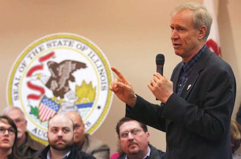Illinois Gov. Bruce Rauner talks about economic issues in Illinois during his stop at the Decatur Conference Center and Hotel in Decatur, Ill., Monday March 23, 2015. The workers are seeking to join a similar lawsuit filed last month by Rauner. (AP Photo/Herald & Review, Jim Bowling)
