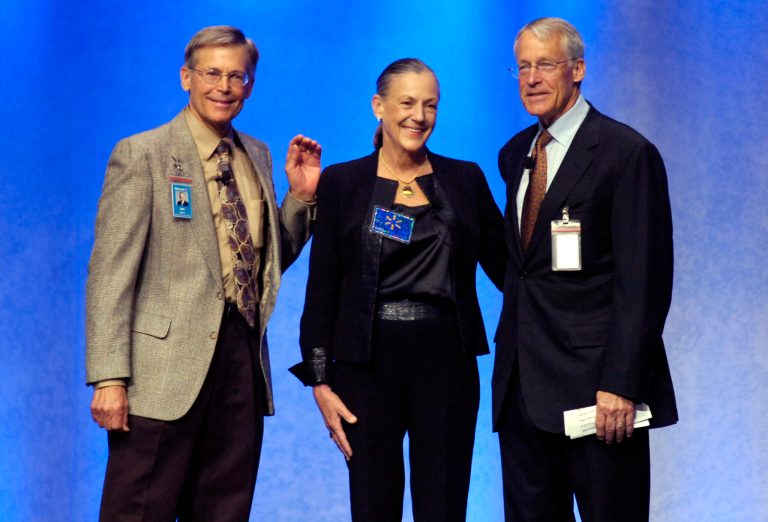 Walton siblings, Jim, left, Alice, and Rob Walton, right, children of the late Wal-Mart Stores Inc. founder Sam Walton, appear on stage during the annual Wal-Mart shareholder's meeting in Fayetteville, Ark., June 5, 2009. (AP/April L. Brown)