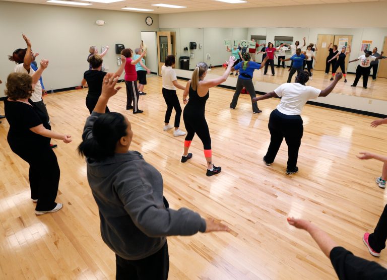 In this April 18, 2014 photo, people take part in a Bokwa fitness class at the Healthy Living Center located in a Hannaford supermarket in Albany, N.Y. The idea for the in-store gym grew out of a meeting last summer between Hannaford, the local YMCA and the health care provider Capital District Physicians' Health Plan. All said their goal was to come up with something to improve the area's health while also being convenient, accessible and free.  (AP Photo/Mike Groll)