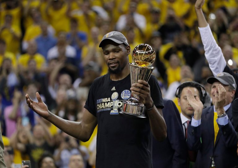 Golden State Warriors forward Kevin Durant holds the Bill Russell NBA Finals Most Valuable Player Award after Game 5 of basketball's NBA Finals between the Warriors and the Cleveland Cavaliers in Oakland, Calif., on Monday. His team has yet to receive an invitation to the White House, and the media needs to apply better scrutiny rather than spreading falsehoods, further eroding the public's trust. (AP Photo/Marcio Jose Sanchez)