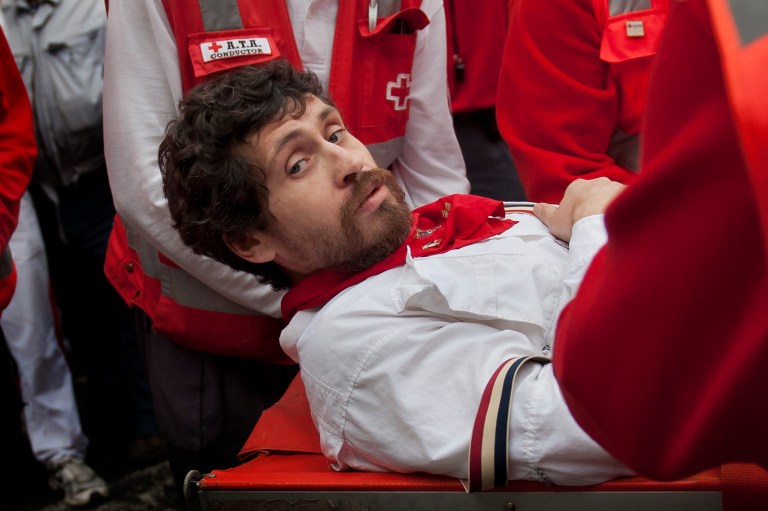 U.S. runner Bill Hillmann, 35, from Chicago, Ill., is carried on a stretcher after being gored on his right leg by a Victoriano del Rio ranch fighting bull during the running of the bulls at the San Fermin festival in Pamplona, Spain, Wednesday, July 9, 2014. A journalist and author, Hillmann, is a veteran San Fermin runner and has written many pieces about the festival. The injury was said to be serious but his life was not in any danger. Revelers from around the world arrive in Pamplona every year to take part on some of the eight days of the running of the bulls glorified by Ernest Hemingway's 1926 novel 