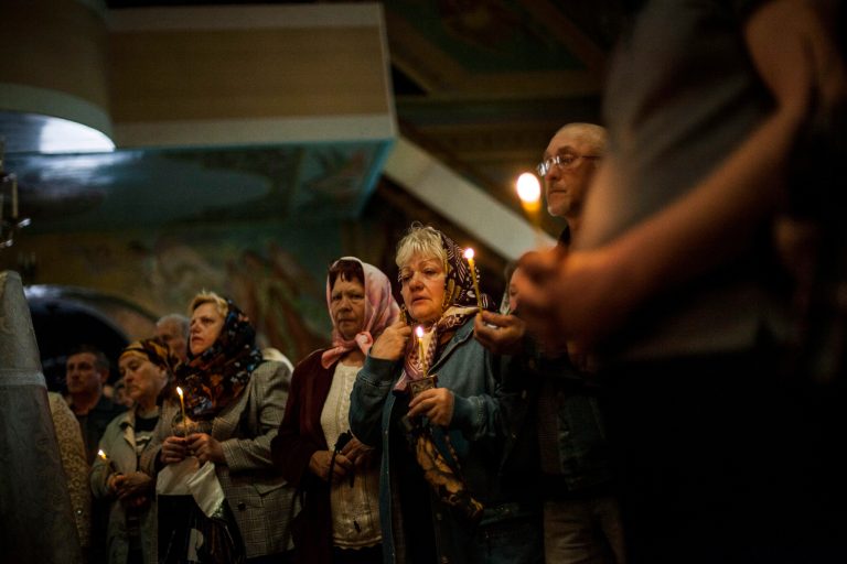 Mourners attend the funeral of 21-year old nurse Yulia Izotova in Kramatorsk, Ukraine, Monday, May 5, 2014. Witnesses say Izotova was killed by shots from a Ukrainian military column on the road near Kramatorsk. Ukraine sent an elite national guard unit to re-establish control Monday over the southern port of Odessa and government troops fought pitched gunbattles with a pro-Russia militia around an eastern city. (AP Photo/Manu Brabo)