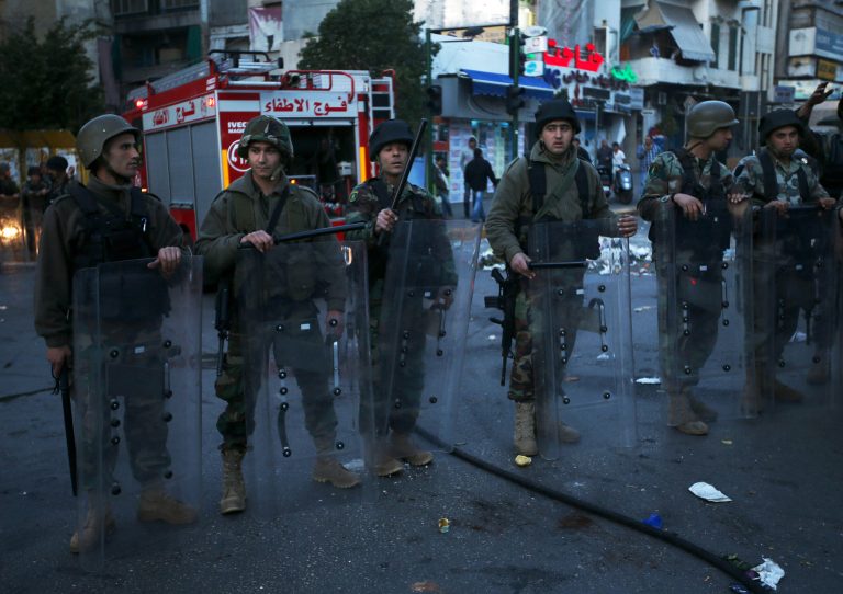 Lebanese army riot soldiers stand guard at a street which was blocked by protesters, after two Sunni Muslim sheikhs at dar al-Fatwa, Lebanon's highest Sunni Authority, were attacked by Shiite men late Sunday, in Beirut, Lebanon, Monday March 18, 2013. A few hundred protesters held a demonstration while others blocked roads after four Sunni Muslim sheiks were assaulted in two separate incidents that inflamed sectarian sentiment in the country. Tensions have been running high in Lebanon in recent months, mainly because of the Syrian civil war raging next door. (AP Photo/Hussein Malla)