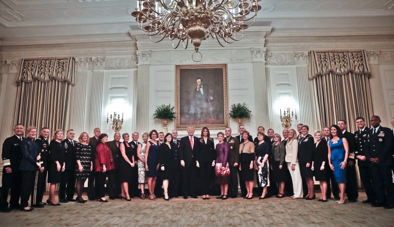 President Donald Trump and first lady Melania Trump, center, poses for a group photo with Senior Military leaders and spouses in the State Dining Room of the White House in Washington, Thursday, Oct. 5, 2017. Trump was hosting the dinner for the group this evening. (AP Photo/Pablo Martinez Monsivais)