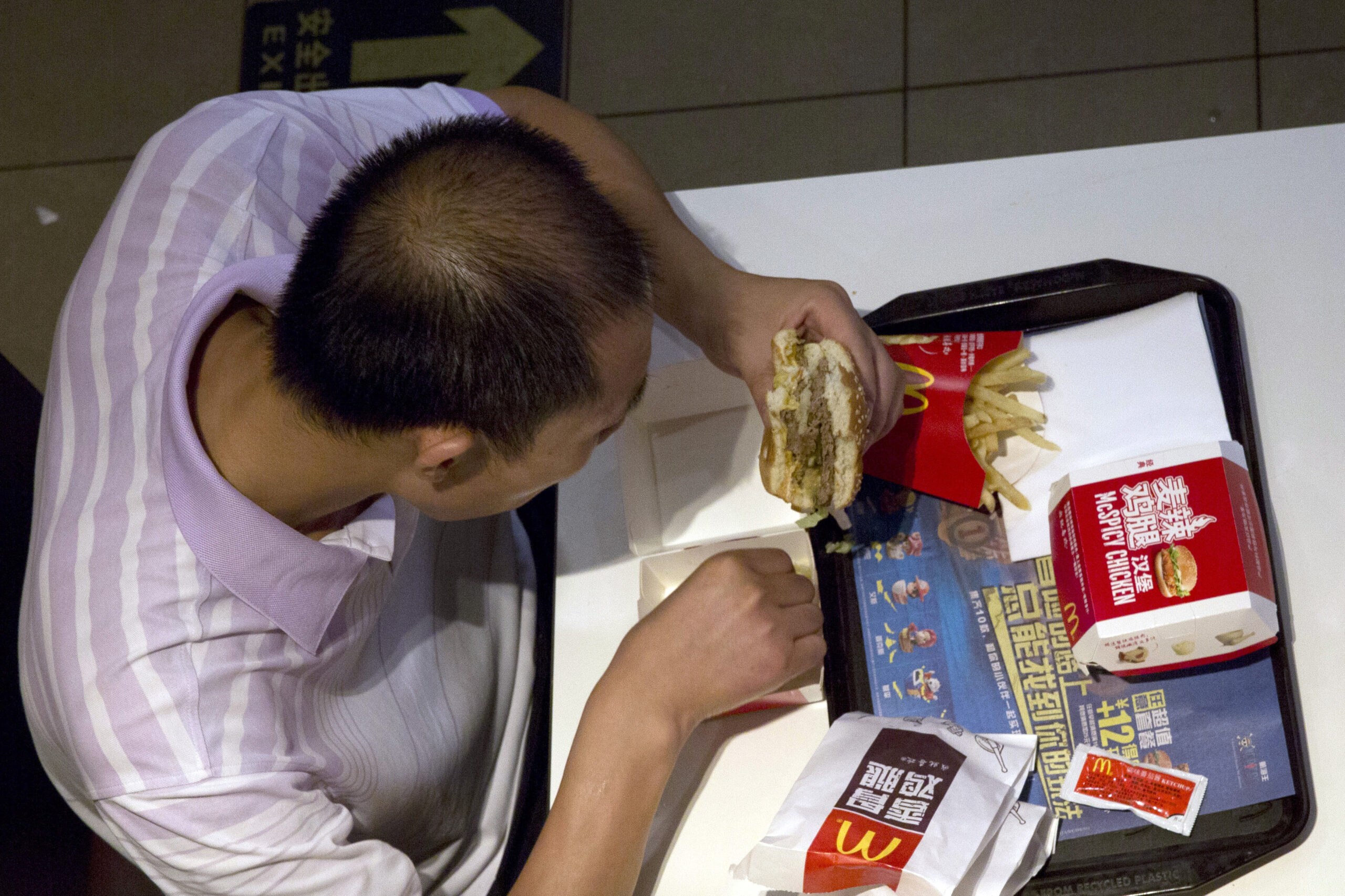 China detains employees of suspect meat seller