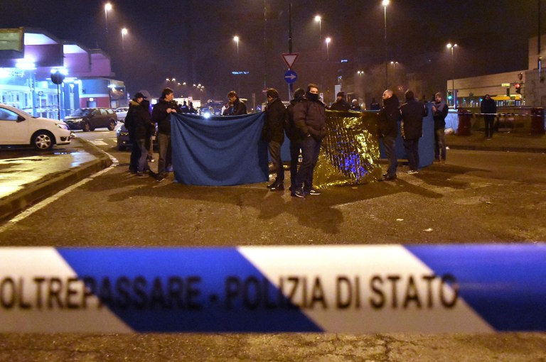 Italian Police cordon off an area after a shootout between police and a man near a train station in Milan's Sesto San Giovanni neighborhood, Italy, early Friday, Dec. 23, 2016. Italy's interior minister Marco Minniti says the man killed in an early-hours shootout in Milan is "without a shadow of doubt" the Berlin Christmas market attacker Anis Amri. (AP Photo/Daniele Bennati)