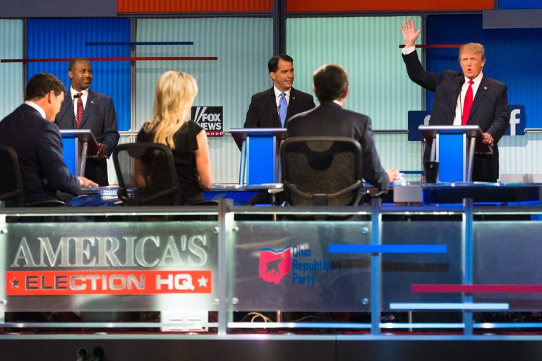 Republican presidential candidate Donald Trump, right, speaks to moderators from left foreground, Bret Baier, Megyn Kelly and Chris Wallace during the first Republican presidential debate at the Quicken Loans Arena Thursday, Aug. 6, 2015, in Cleveland. (AP Photo/John Minchillo)