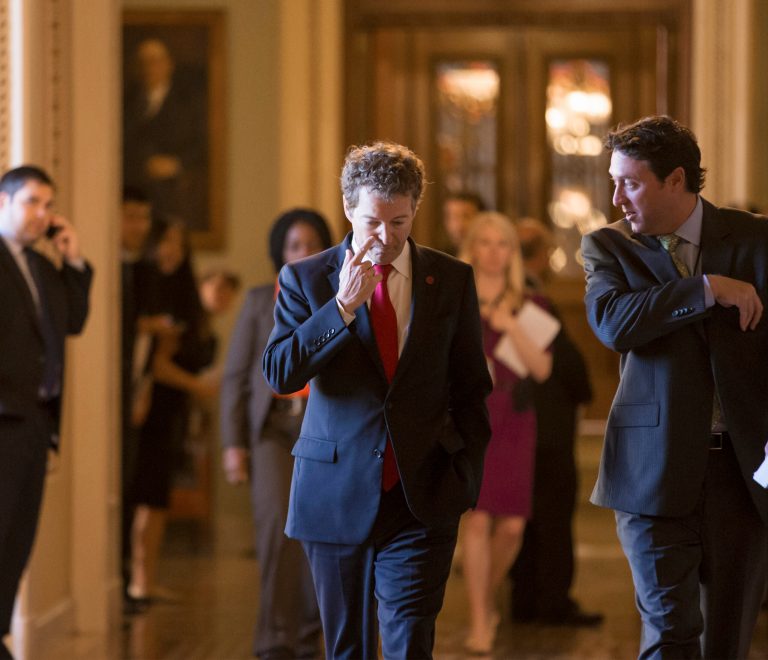 Sen. Rand Paul, R-Ky., center, and other lawmakers walk to their party caucuses at the Capitol in Washington on Tuesday. (AP Photo/J. Scott Applewhite)