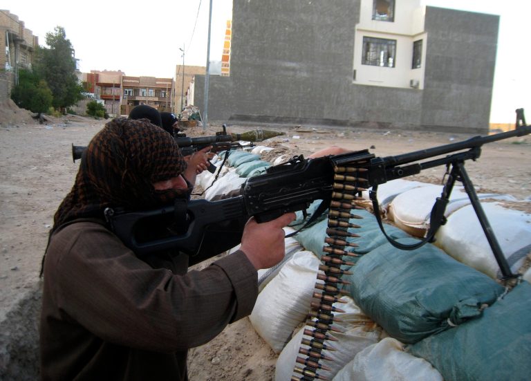 In this Friday, April 11, 2014 photo, masked anti-government gunmen hold their weapons in combat position in Fallujah, 65 kilometers (40 miles) west of Baghdad, Iraq. Al-Qaida-linked fighters and their allies seized the city of Fallujah and parts of the Anbar provincial capital Ramadi in late December after authorities dismantled a protest camp. Like the camp in the northern Iraqi town of Hawija whose dismantlement in April sparked violent clashes and set off the current upsurge in killing, the Anbar camp was set up by Sunnis angry at what they consider second-class treatment by the Shiite-led government. (AP Photo)