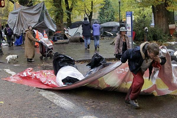 Occupy Portland protestors are forced out of their temporary shelters last year by local law enforcement officers. (AP Photo)