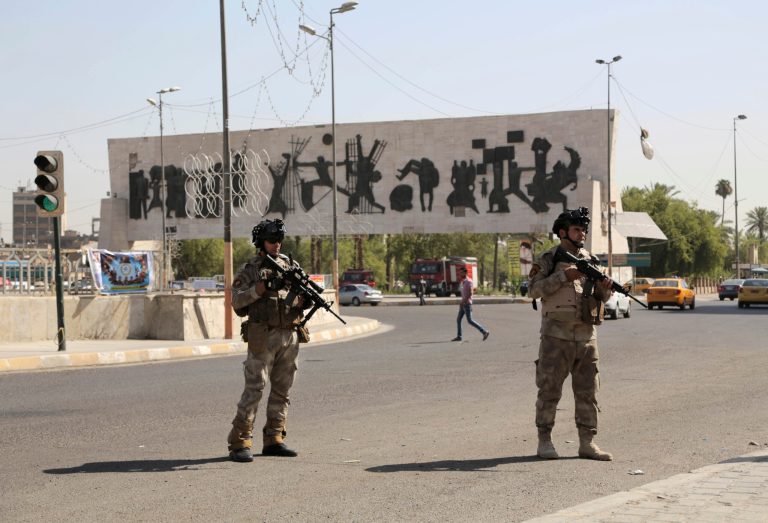 Iraqi army soldiers stand guard at Tahrir Square in Baghdad, Iraq, Monday, June 16, 2014. (AP Photo/Khalid Mohammed)