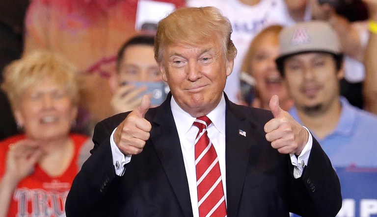 President Trump gestures to the crowd while speaking at a rally in Phoenix. (AP Photo/Rick Scuteri)
