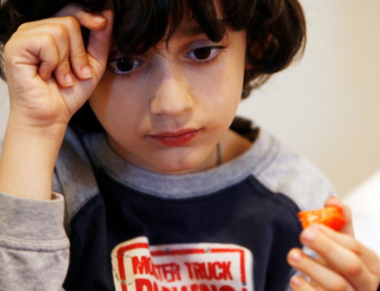 Eight-year-old Charlie Blakey, who was diagnosed with autism at age 3, eats dinner andÂ swallows chelation pillsÂ at his home on Oak Park, Ill., on April 23, 2008. (AP Photo/Nam Y. Huh)
