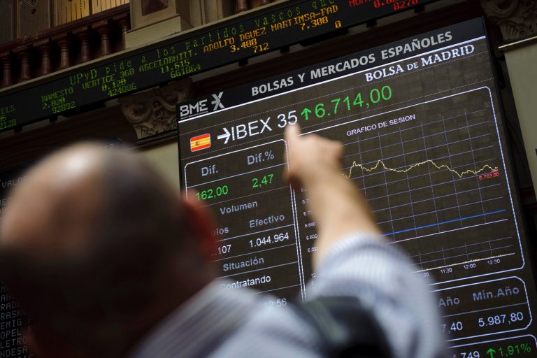   A visitor points his finger towards the Stock Exchange's main display, in Madrid, Monday June 11, 2012. After Spain's request for a European financial lifeline of up to a euro100 billion euros ($125 billion) to save its banks the EU made clear the money is more than just a loan. Besides being paid back with interest, there will be strings attached for the Spanish government.(AP Photo/Daniel Ochoa de Olza)  
