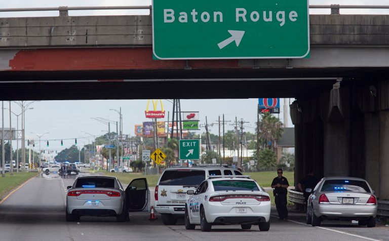 Baton Rouge Police block Airline Highway after police were shot in Baton Rouge, La., Sunday, July 17, 2016. At least three officers are confirmed dead and at least three others wounded after the shooting, a sheriff's office spokeswoman said Sunday. (AP Photo/Max Becherer)