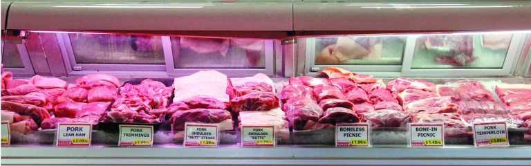 Meat is on display in a case at Super Cao Nguyen in Oklahoma City, Wednesday, July 25, 2012. Butcher Freddie Quina cuts meat at Super Cao Nguyen in Oklahoma City, Wednesday, July 25, 2012. The record drought gripping half the country will help push food prices up by 3 percent to 4 percent next year, the U.S. Department of Agriculture said. (AP Photo/Sue Ogrocki)